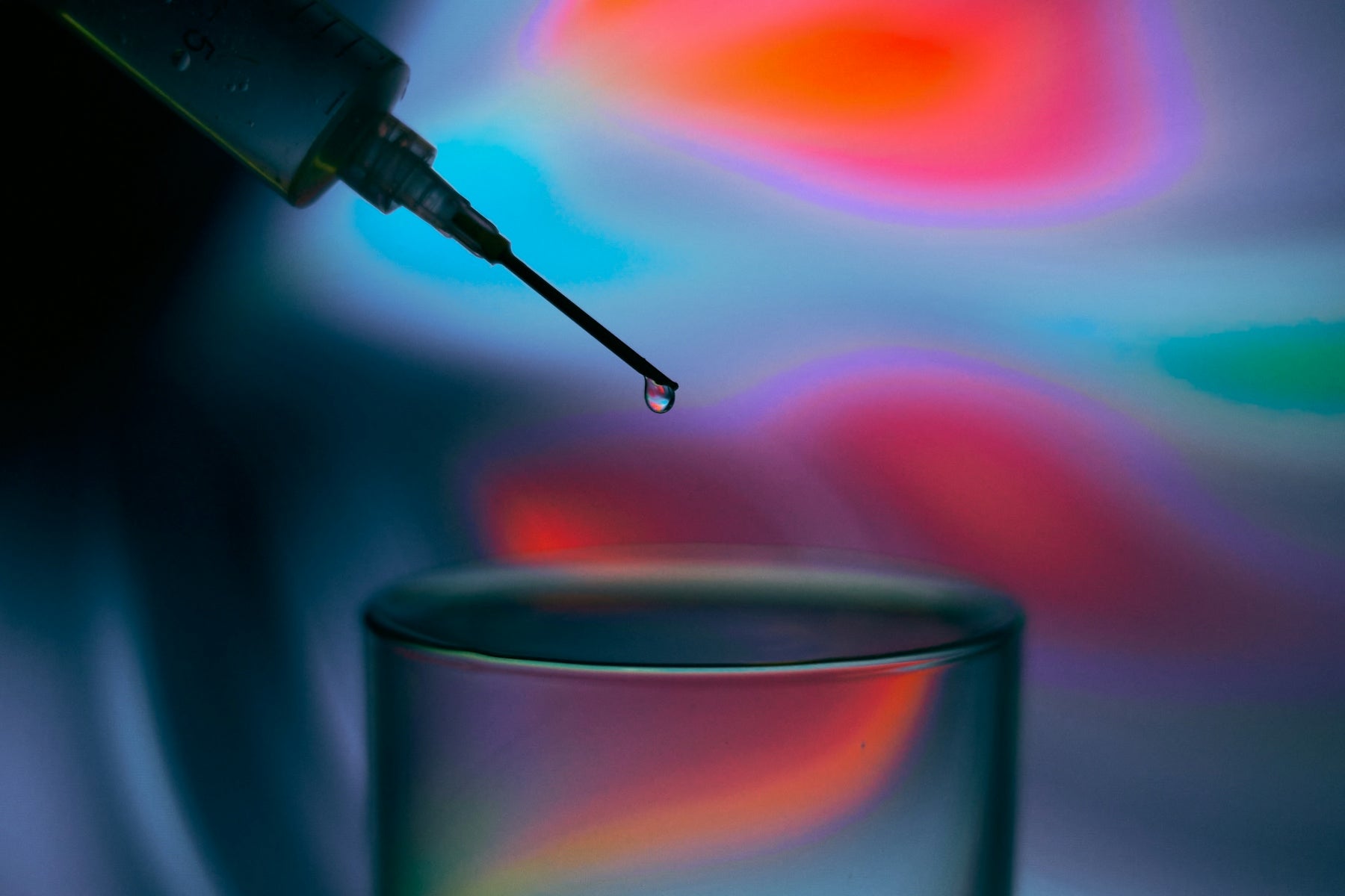 a drop of liquid in a glass of water