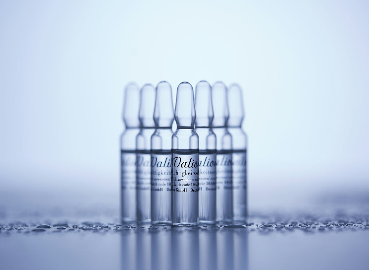a row of clear bottles sitting on top of a table