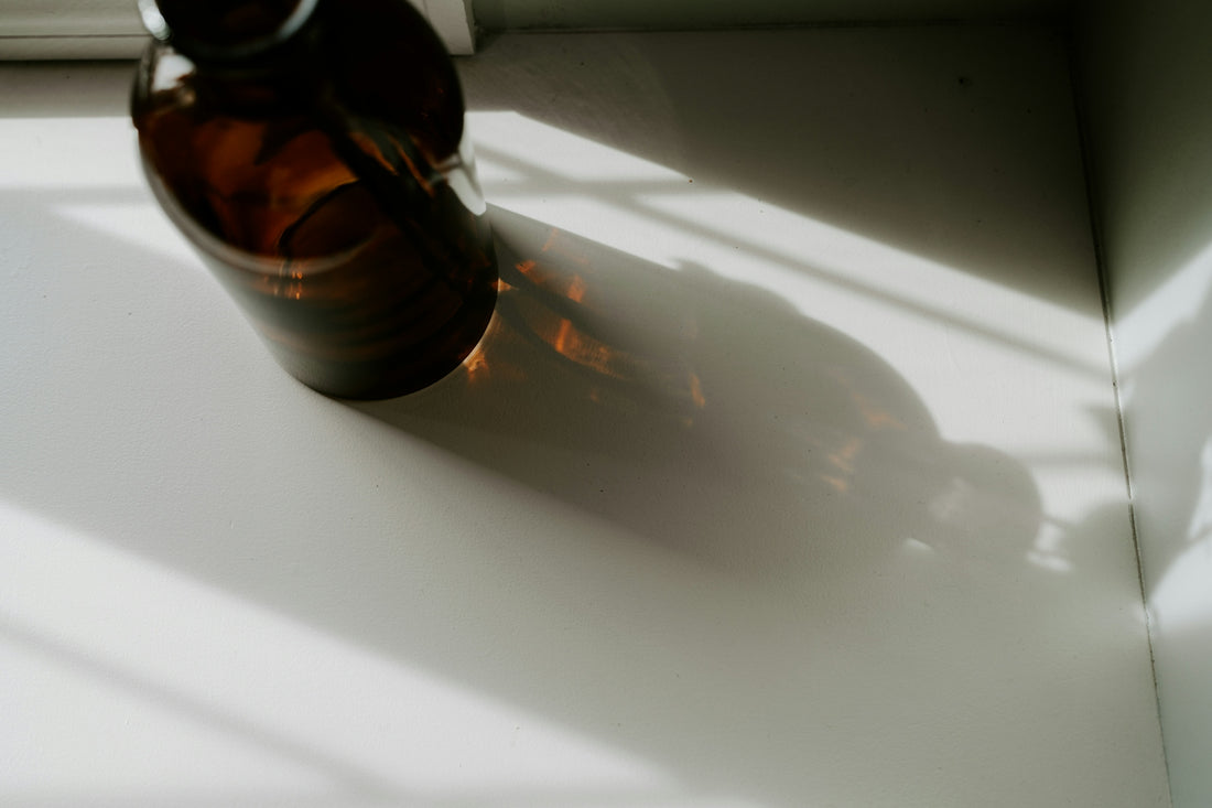 A brown bottle sitting on top of a white table